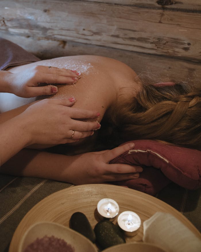 A serene spa exfoliation treatment with soothing candles and gentle skincare.
